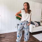 Washed navy thin, lightweight wide leg pants with taupe and navy florals throughout, metal floral button down closure, elastic back waist, elastic cuffs and side and oversized back pockets.