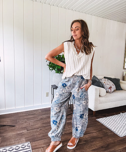 Washed navy thin, lightweight wide leg pants with taupe and navy florals throughout, metal floral button down closure, elastic back waist, elastic cuffs and side and oversized back pockets.