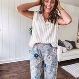 Washed navy thin, lightweight wide leg pants with taupe and navy florals throughout, metal floral button down closure, elastic back waist, elastic cuffs and side and oversized back pockets.