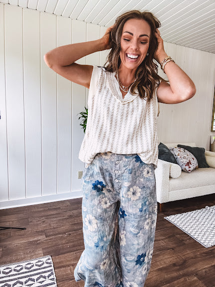Washed navy thin, lightweight wide leg pants with taupe and navy florals throughout, metal floral button down closure, elastic back waist, elastic cuffs and side and oversized back pockets.