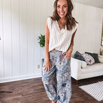 Washed navy thin, lightweight wide leg pants with taupe and navy florals throughout, metal floral button down closure, elastic back waist, elastic cuffs and side and oversized back pockets.