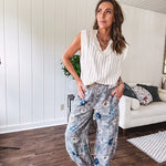 Washed navy thin, lightweight wide leg pants with taupe and navy florals throughout, metal floral button down closure, elastic back waist, elastic cuffs and side and oversized back pockets.