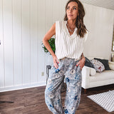 Washed navy thin, lightweight wide leg pants with taupe and navy florals throughout, metal floral button down closure, elastic back waist, elastic cuffs and side and oversized back pockets.