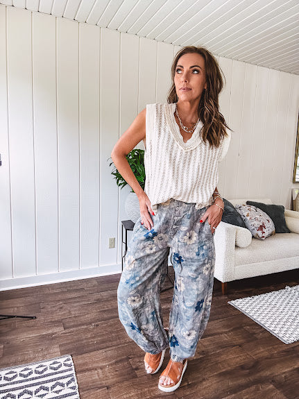 Washed navy thin, lightweight wide leg pants with taupe and navy florals throughout, metal floral button down closure, elastic back waist, elastic cuffs and side and oversized back pockets.