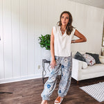 Washed navy thin, lightweight wide leg pants with taupe and navy florals throughout, metal floral button down closure, elastic back waist, elastic cuffs and side and oversized back pockets.