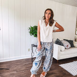 Washed navy thin, lightweight wide leg pants with taupe and navy florals throughout, metal floral button down closure, elastic back waist, elastic cuffs and side and oversized back pockets.