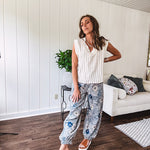 Washed navy thin, lightweight wide leg pants with taupe and navy florals throughout, metal floral button down closure, elastic back waist, elastic cuffs and side and oversized back pockets.