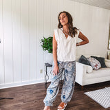 Washed navy thin, lightweight wide leg pants with taupe and navy florals throughout, metal floral button down closure, elastic back waist, elastic cuffs and side and oversized back pockets.