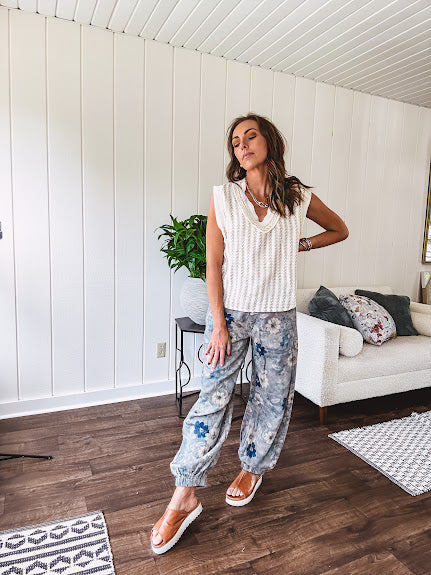 Washed navy thin, lightweight wide leg pants with taupe and navy florals throughout, metal floral button down closure, elastic back waist, elastic cuffs and side and oversized back pockets.
