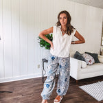 Washed navy thin, lightweight wide leg pants with taupe and navy florals throughout, metal floral button down closure, elastic back waist, elastic cuffs and side and oversized back pockets.