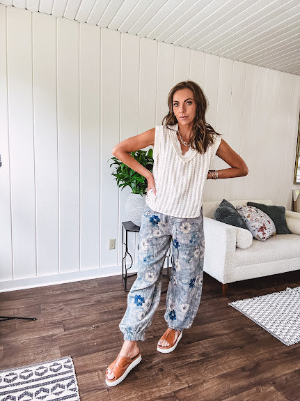 Washed navy thin, lightweight wide leg pants with taupe and navy florals throughout, metal floral button down closure, elastic back waist, elastic cuffs and side and oversized back pockets.