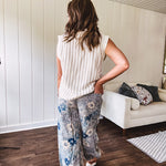 Washed navy thin, lightweight wide leg pants with taupe and navy florals throughout, metal floral button down closure, elastic back waist, elastic cuffs and side and oversized back pockets.