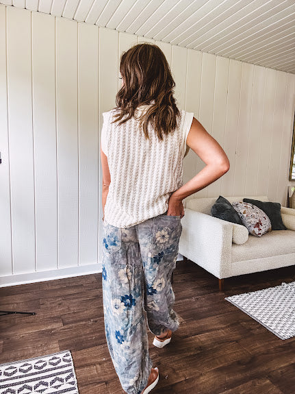 Washed navy thin, lightweight wide leg pants with taupe and navy florals throughout, metal floral button down closure, elastic back waist, elastic cuffs and side and oversized back pockets.