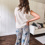 Washed navy thin, lightweight wide leg pants with taupe and navy florals throughout, metal floral button down closure, elastic back waist, elastic cuffs and side and oversized back pockets.
