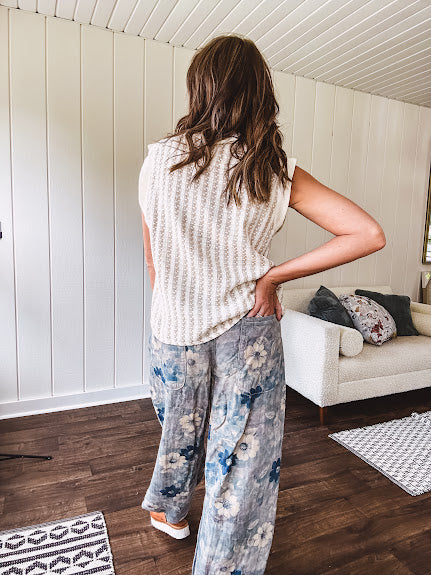 Washed navy thin, lightweight wide leg pants with taupe and navy florals throughout, metal floral button down closure, elastic back waist, elastic cuffs and side and oversized back pockets.