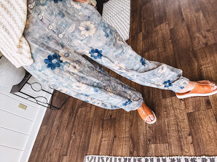 Washed navy thin, lightweight wide leg pants with taupe and navy florals throughout, metal floral button down closure, elastic back waist, elastic cuffs and side and oversized back pockets.