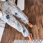 Washed navy thin, lightweight wide leg pants with taupe and navy florals throughout, metal floral button down closure, elastic back waist, elastic cuffs and side and oversized back pockets.