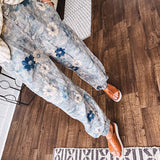 Washed navy thin, lightweight wide leg pants with taupe and navy florals throughout, metal floral button down closure, elastic back waist, elastic cuffs and side and oversized back pockets.