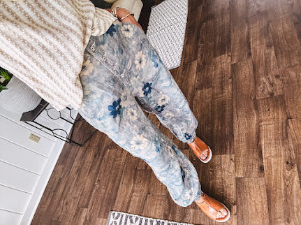 Washed navy thin, lightweight wide leg pants with taupe and navy florals throughout, metal floral button down closure, elastic back waist, elastic cuffs and side and oversized back pockets.