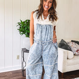 Vintage light wash denim and twill overalls with silver metal adjustable strap hardware, side zip, side and back pockets with ivory eyelet trim and cutouts throughout, wide leg design.