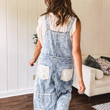 Vintage light wash denim and twill overalls with silver metal adjustable strap hardware, side zip, side and back pockets with ivory eyelet trim and cutouts throughout, wide leg design.