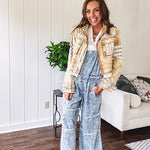 Vintage light wash denim and twill overalls with silver metal adjustable strap hardware, side zip, side and back pockets with ivory eyelet trim and cutouts throughout, wide leg design.