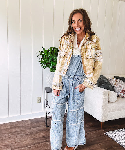 Lightweight antique bronze washed zip up denim jacket with exposed seams, ivory lace detail throughout, 3D pockets on the front, strap adjustable cuffs and lace trim at the hem.