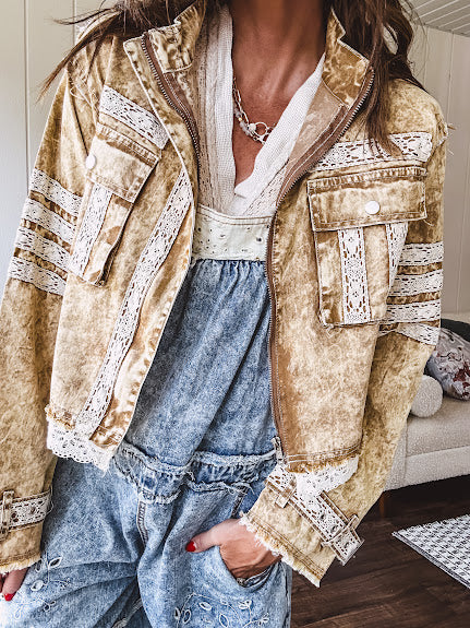 Lightweight antique bronze washed zip up denim jacket with exposed seams, ivory lace detail throughout, 3D pockets on the front, strap adjustable cuffs and lace trim at the hem.