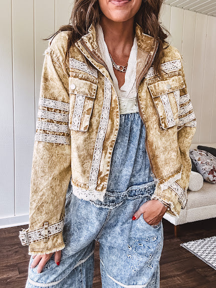 Lightweight antique bronze washed zip up denim jacket with exposed seams, ivory lace detail throughout, 3D pockets on the front, strap adjustable cuffs and lace trim at the hem.