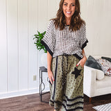 Cotton lightweight moss green joggers with mauve dainty floral print and black knit striping and star patch detail throughout, button and zipper closure with rope grommet stye belt, side pockets and elastic cuffs.