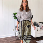 Cotton lightweight moss green joggers with mauve dainty floral print and black knit striping and star patch detail throughout, button and zipper closure with rope grommet stye belt, side pockets and elastic cuffs.