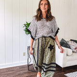 Cotton lightweight moss green joggers with mauve dainty floral print and black knit striping and star patch detail throughout, button and zipper closure with rope grommet stye belt, side pockets and elastic cuffs.