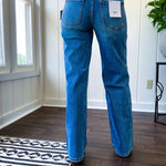 Medium wash wide leg high rise denim with no distressing and finished hem.