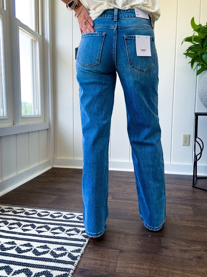 Medium wash wide leg high rise denim with no distressing and finished hem.
