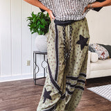 Cotton lightweight moss green joggers with mauve dainty floral print and black knit striping and star patch detail throughout, button and zipper closure with rope grommet stye belt, side pockets and elastic cuffs.