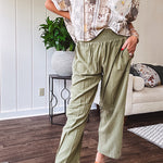 Lightweight olive smocked waist pants with side pockets and knee darts, cropped style.