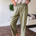 Lightweight olive smocked waist pants with side pockets and knee darts, cropped style.