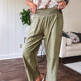 Lightweight olive smocked waist pants with side pockets and knee darts, cropped style.