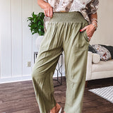 Lightweight olive smocked waist pants with side pockets and knee darts, cropped style.