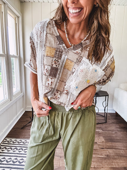 Lightweight and flowy beige patchwork printed tee with V neck, raw seams and cream lace inserts and floral crochet floral patch on the front pocket.