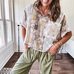 Lightweight and flowy beige patchwork printed tee with V neck, raw seams and cream lace inserts and floral crochet floral patch on the front pocket.