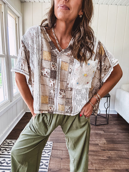 Lightweight and flowy beige patchwork printed tee with V neck, raw seams and cream lace inserts and floral crochet floral patch on the front pocket.