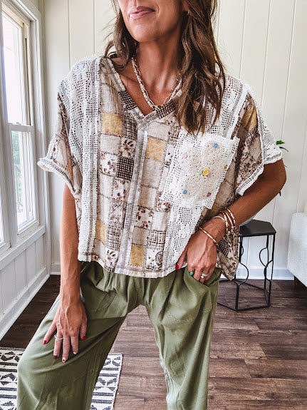 Lightweight and flowy beige patchwork printed tee with V neck, raw seams and cream lace inserts and floral crochet floral patch on the front pocket.