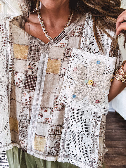 Lightweight and flowy beige patchwork printed tee with V neck, raw seams and cream lace inserts and floral crochet floral patch on the front pocket.