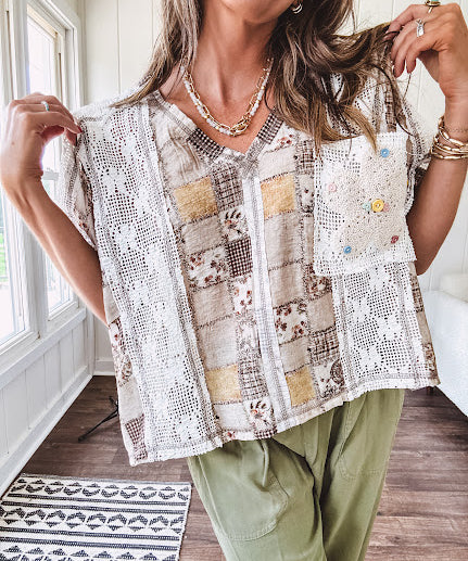 Lightweight and flowy beige patchwork printed tee with V neck, raw seams and cream lace inserts and floral crochet floral patch on the front pocket.