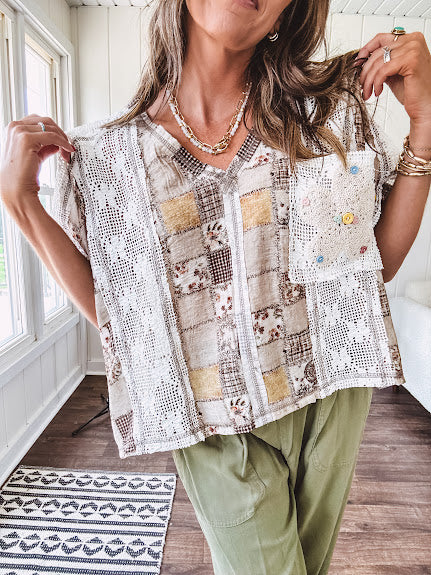 Lightweight and flowy beige patchwork printed tee with V neck, raw seams and cream lace inserts and floral crochet floral patch on the front pocket.