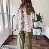 Lightweight and flowy beige patchwork printed tee with V neck, raw seams and cream lace inserts and floral crochet floral patch on the front pocket.