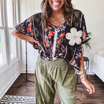 Lightweight olive smocked waist pants with side pockets and knee darts, cropped style.