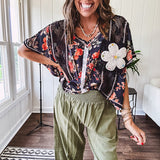 Lightweight olive smocked waist pants with side pockets and knee darts, cropped style.