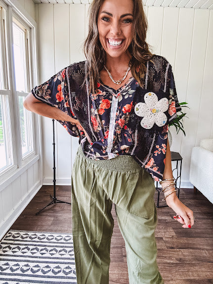 Lightweight olive smocked waist pants with side pockets and knee darts, cropped style.
